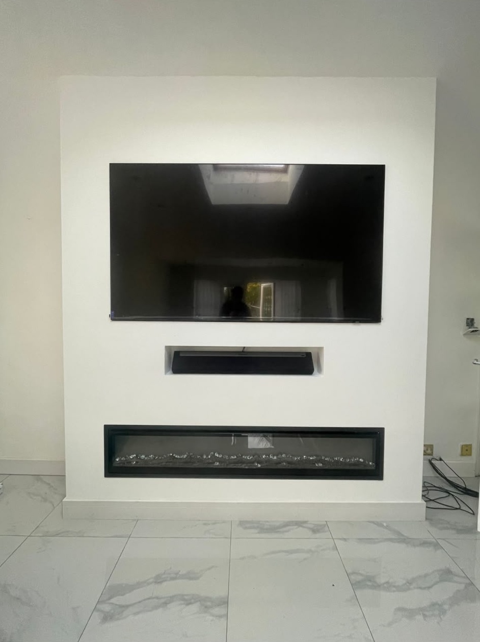 Plastered media wall with a recessed television, soundbar and inset electric fire finished smooth